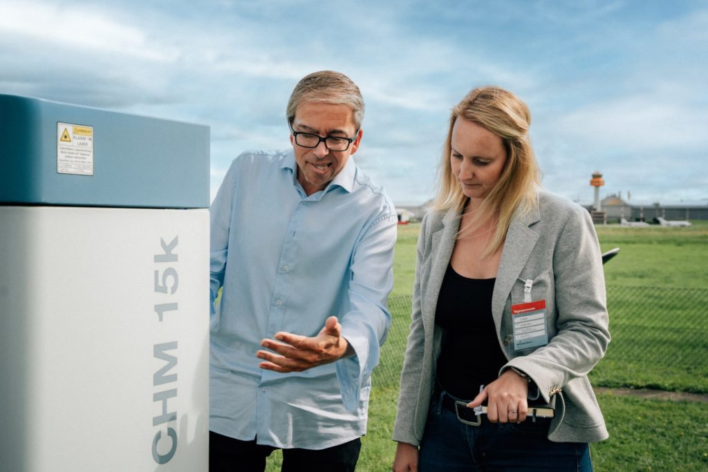 Aufmerksam zuhören: DWD-Mitarbeiter Marc Wenthe erklärt Flugschülerin Isabella Sauer das Wolkenmessgerät und dessen Lasertechnik. Foto: Tim Reichert